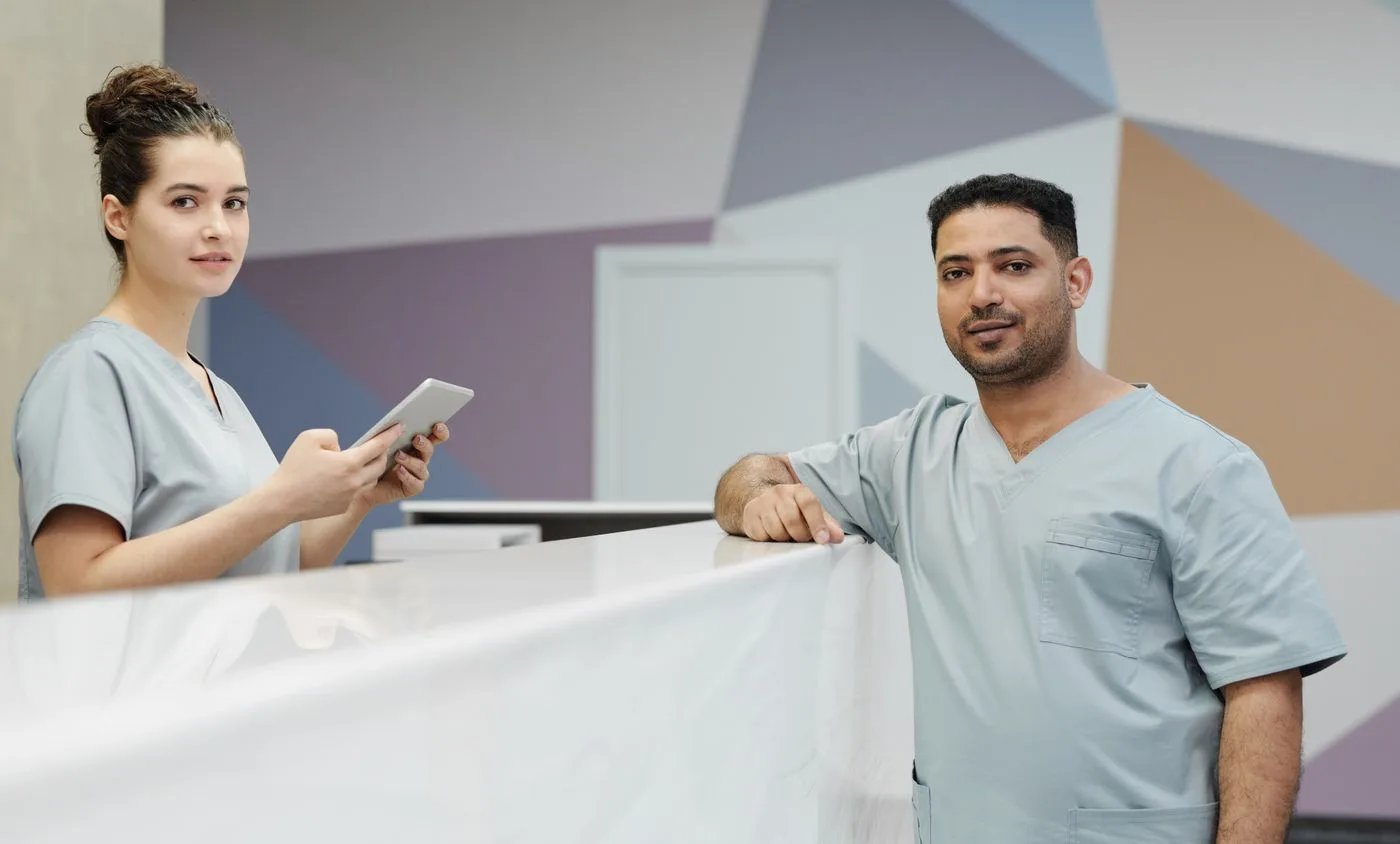 Clinical staff at a modern facility front desk